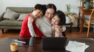 iLEAD Lancaster Charter School mom with children at laptop